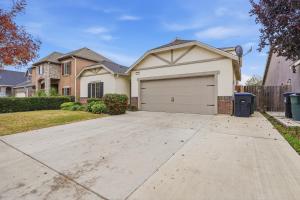 une maison avec une allée et un garage dans l'établissement Casa Cortez, à Visalia