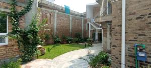 a courtyard of a brick building with a yard at Morgah Resort - Guest Rooms in Rawalpindi