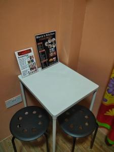 a white table with two stools next to it at Tipid Camp Baguio A2,A3,A7,A8 in Baguio