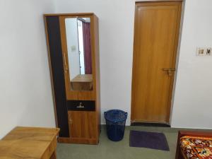 a room with a mirror and a wooden door at Agapi Homestay in Cochin