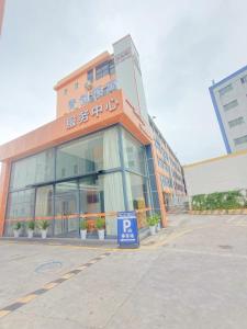 a building with a parking sign in front of it at Youth Innovation Apartment in Guangzhou