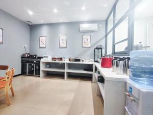 a large kitchen with a white counter in a room at Youth Innovation Apartment in Guangzhou