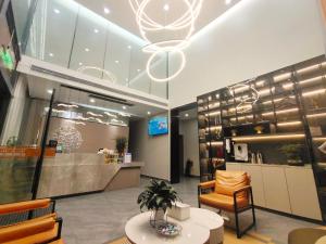 a lobby of a store with a chair and a table at Youth Innovation Apartment in Guangzhou