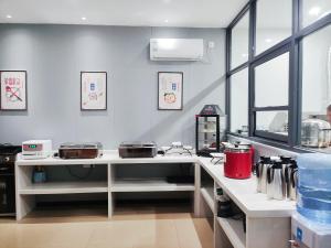 a kitchen with a counter with several pans on it at Youth Innovation Apartment in Guangzhou