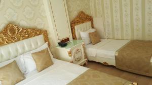 Postel nebo postele na pokoji v ubytování Best Town Hotel