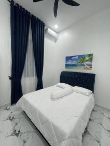 a bedroom with a bed with a blue curtain at Farisya Homestay in Kota Bharu