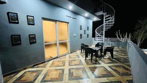 a room with chairs and a table and a staircase at Holiday Home Villa in Thūr