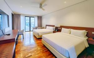 a hotel room with two beds and a desk at Awesome Hotel in San Juan +161 photos