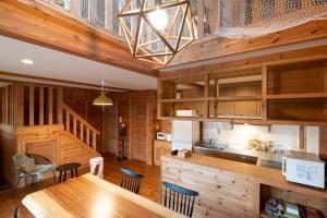 a kitchen and dining room with a table and chairs at yado suzuka 1 in Suzuka