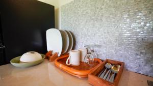 a counter with a tray with dishes and a mirror at D'Penglipuran Jungle House in Susut