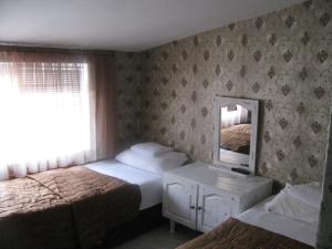 Postel nebo postele na pokoji v ubytování Family Hotel Kartala