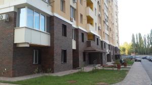 a brick building with a bench next to a street at Apartment Sofia 1 in Volgograd