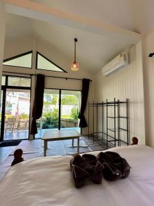a bedroom with a bed with a table in the middle at Chaloklumbay resort2 in Mae Haad +93 photos