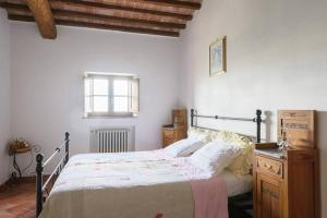a bedroom with a large bed and a window at Relax Palazzo Monaci in Asciano
