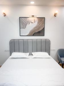 En eller flere senge i et værelse på The Boutique Stay