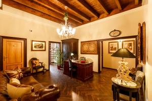 a living room filled with furniture and a chandelier at Villa Pallotta Luxury B&B in Cerignola