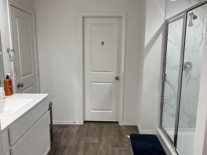 a bathroom with a shower and a white door at Homely in Richmond +58 photos