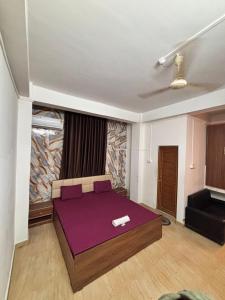 een slaapkamer met een paars bed in een kamer bij The Modern Home Stay in Guwahati