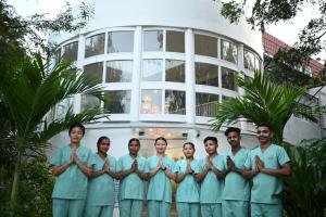a group of surgeons standing in front of a building at VSR Vriksha Wellness Nature Cure Center in Hyderabad