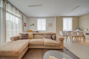 a living room with a couch and a dining room at St Julian's 2Br Apartment with Private Jacuzzi in St. Julianʼs
