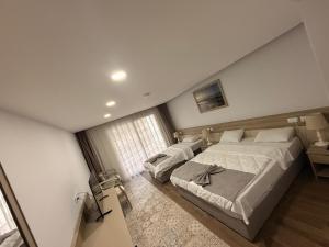 a bedroom with two beds and a window at Altinkaya Holiday Resort in Kyrenia +6 photos