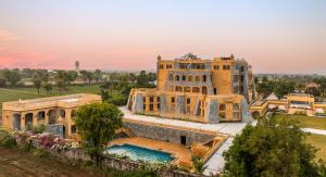 an aerial view of a mansion with a swimming pool at Raj Leela Heritage Resort By Estherea in Jāmb