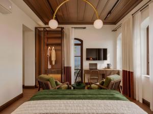a bedroom with a bed and chairs and a desk at Castellion Hotels Galata in Istanbul +28 photos