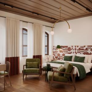 a bedroom with a large bed and two chairs at Castellion Hotels Galata in Istanbul
