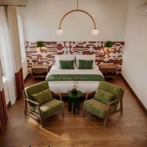 a bedroom with a large bed and two chairs at Castellion Hotels Galata in Istanbul