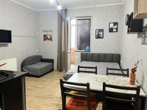 a living room with a bed and a table and a couch at Family Studio in Gudauri