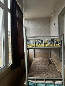 a bunk bed in a room with a window at Family Studio in Gudauri