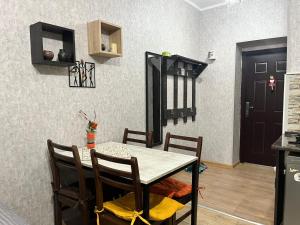 a dining room with a table and chairs and a door at Family Studio in Gudauri +4 photos