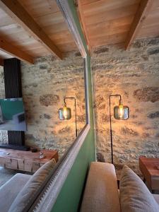 a room with two lights on a stone wall at Gîte de Marcenac in Lalbenque +34 photos