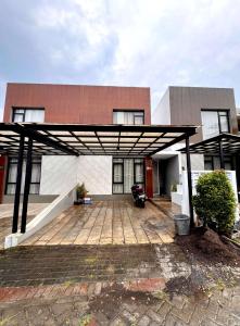 a building with a covered patio in front of it at Villa FiFa in Blimbing