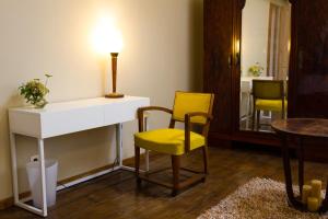 a room with a table and two chairs and a lamp at Wazemoff in Lille