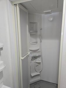 a walk in shower in a bathroom with a shower at Kobe Youth Hostel in Kobe +35 photos