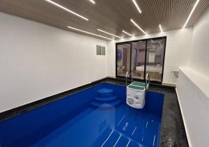 a swimming pool in a room with a bathroom at Sarang Resort Varkala by VOYE HOMES - Includes Rooms with Private Pool in Varkala