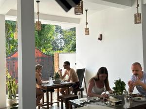 a group of people sitting at tables in a restaurant at Tropictide Weligama in Weligama +102 photos