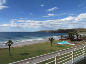 a view of the beach and ocean from a balcony at Point Village Accommodation - Ocean Two 12 in Mossel Bay