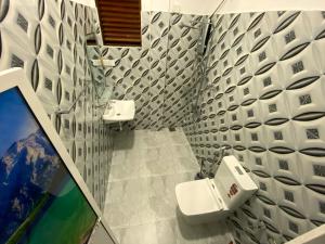 a bathroom with a toilet and a sink at Green Calm Villa in Kamburugamuwa