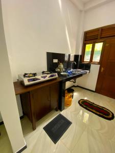a kitchen with a stove and a counter top at Green Calm Villa in Kamburugamuwa +13 photos