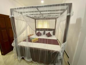 a bedroom with a bed covered in plastic at Green Calm Villa in Kamburugamuwa