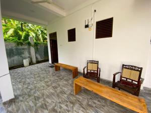a room with two chairs and a bench at Green Calm Villa in Kamburugamuwa