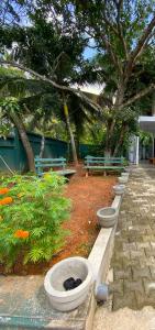 a row of cement benches with a black cat sleeping in them at Green Calm Villa in Kamburugamuwa