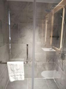 un bagno con doccia con porta in vetro di LN hotel&Residence a Phumĭ Prêk Chrey Altre 3 foto