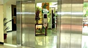 a lobby with a metal elevator in a building at The Ritz Hotel at Garden Oases in Cabaguio