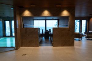 a room with a pool in a house with glass doors at Kaamos Lodge in Aavasaksa