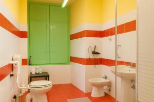 bagno colorato con servizi igienici e lavandino di Sole Rosso Acquario Rooms a Genova Altre 28 foto