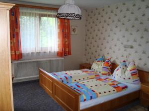 a bedroom with a large bed with pillows at Haus Sonnenrose in Oberau