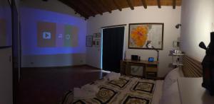 a room with a bedroom with a bed and a desk at Soffio dell'Etna in Puntalazzo +8 photos